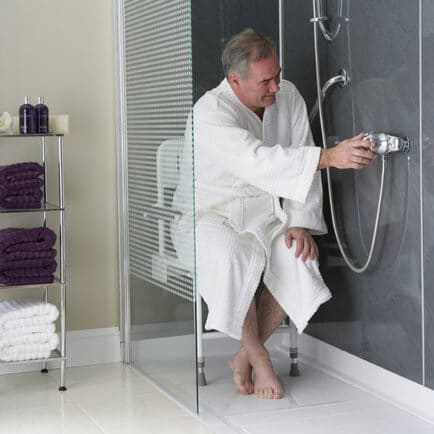 man seated in shower