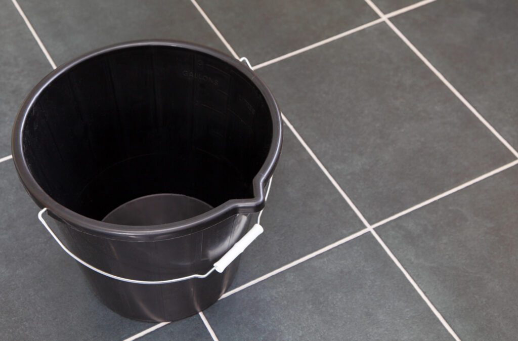 Black bucket on the floor