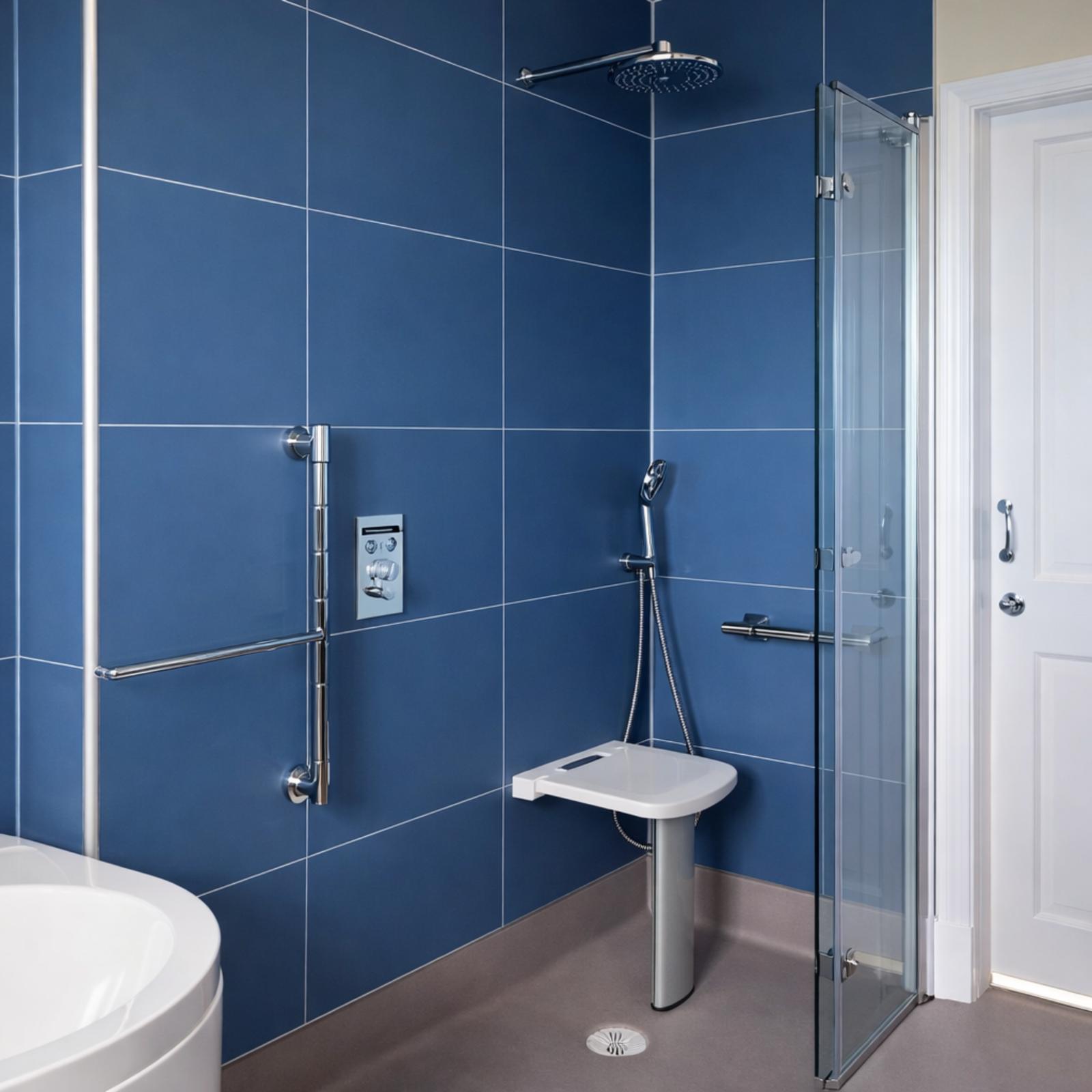accessible-blue-wet-room-grab-rails-shower-seat accessible wet room with level-access shower and non-slip flooring